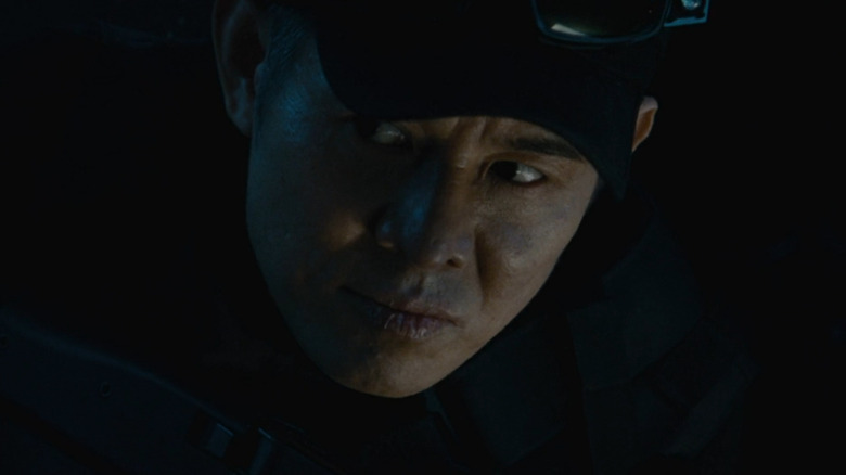 Jet Li wearing hat at night