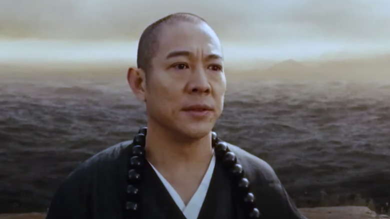 Jet Li standing by ocean