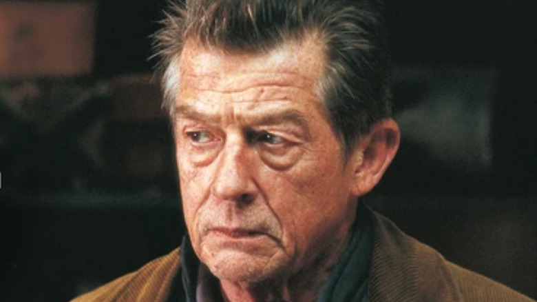 John Hurt looks left