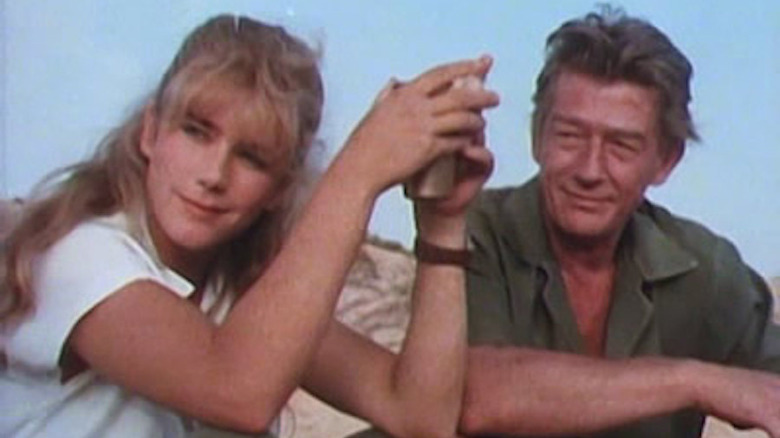 John Hurt and Imogen Stubbs sit on a sand dune