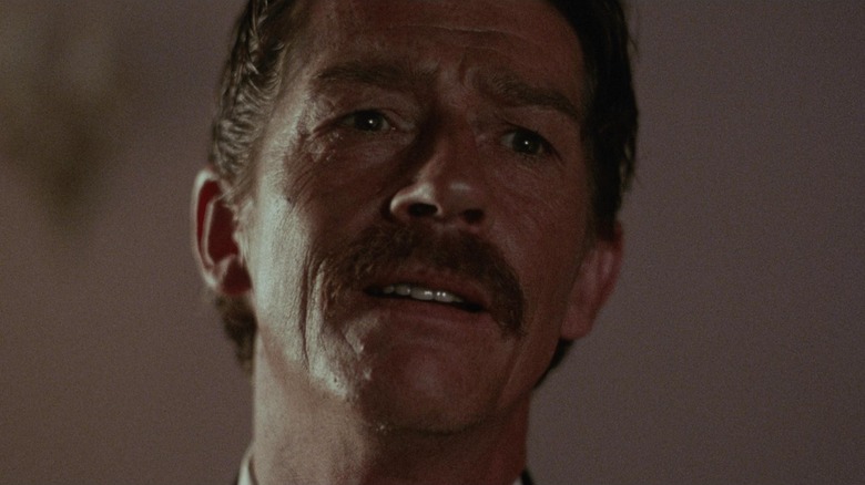 John Hurt tilts his head