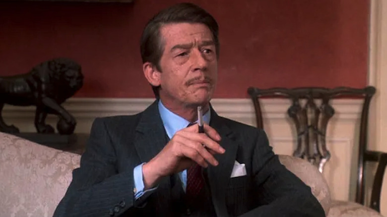 John Hurt smokes in a chair