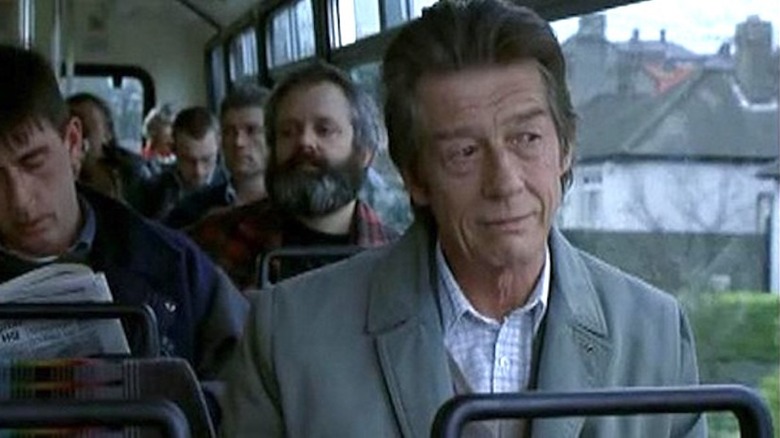 John Hurt rides on a bus