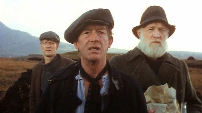 John Hurt, Sean Bean, and Richard Harris in a field