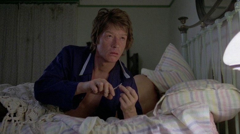 John Hurt cuts his fingernails in bed