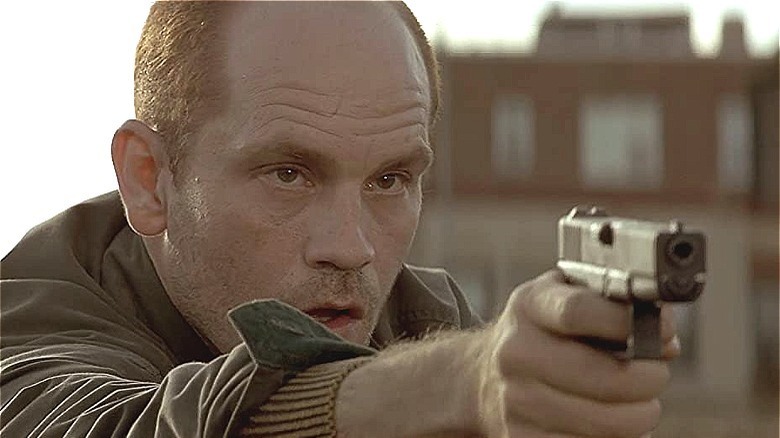 malkovich pointing gun/ in the line of fire