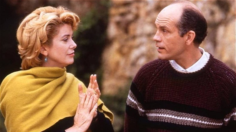 catherine deneuve left, yellow scarf, john malkovich right, red sweater/the convent