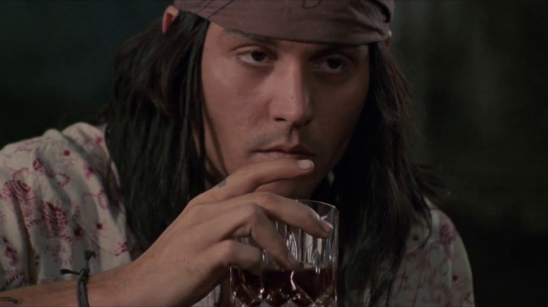 Raphael takes a drink in "The Brave" (1997)