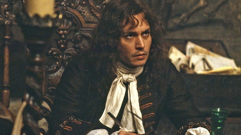 John Wilmot sits at a table in "The Libertine" (2004)