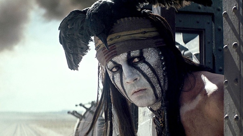 Tonto leans out of a train in "The Lone Ranger" (2013)