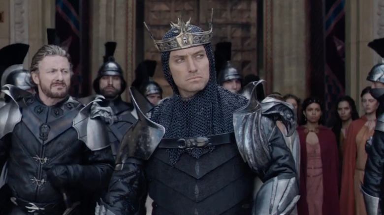 Jude Law wearing armor and crown