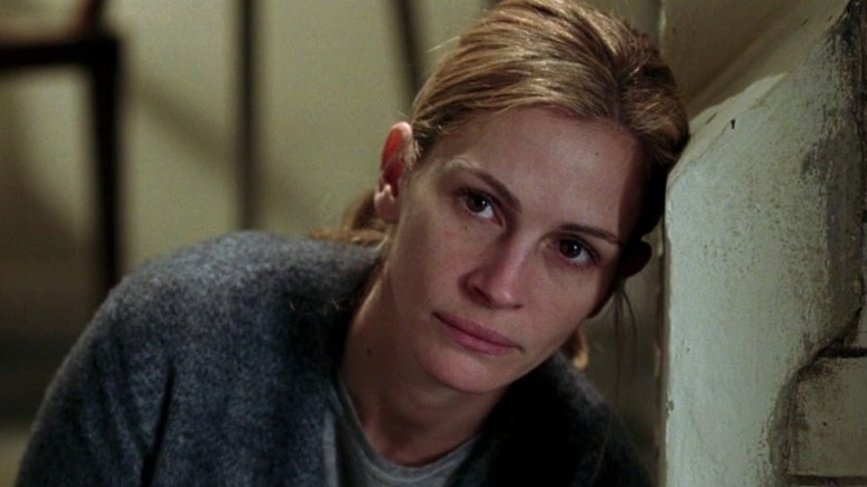 Julia Roberts leaning on a wall looking upset