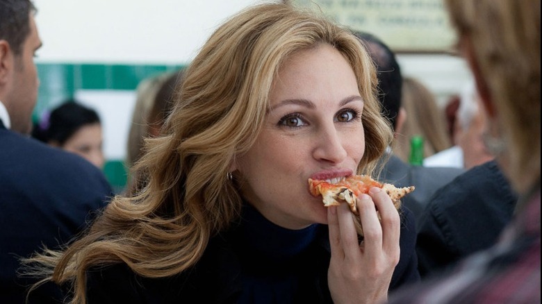 Elizabeth eats a slice of pizza in "Eat Pray Love" (2010)