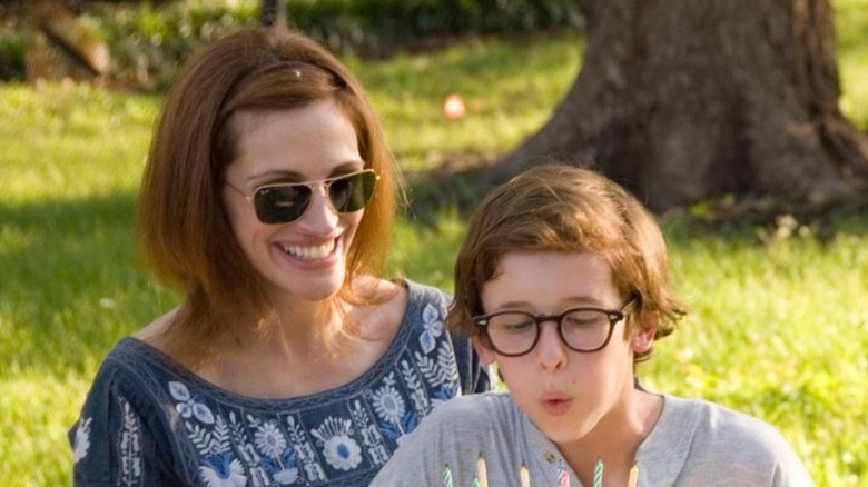 Julia Roberts smiling as young boy blows out birthday candles