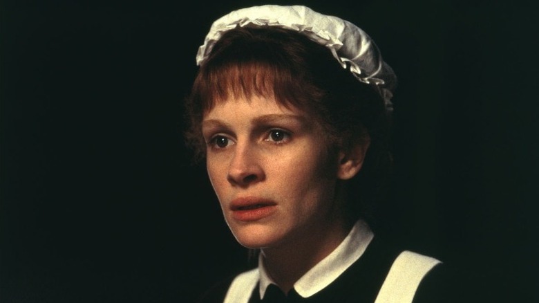 Julia Roberts looking scared in a maid's uniform 