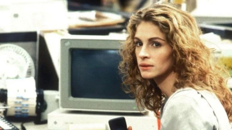 Julia Roberts sitting in front of a computer