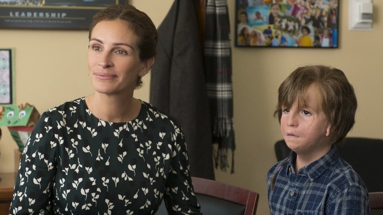 Isabel and August sit in an office in "Wonder" (2017)