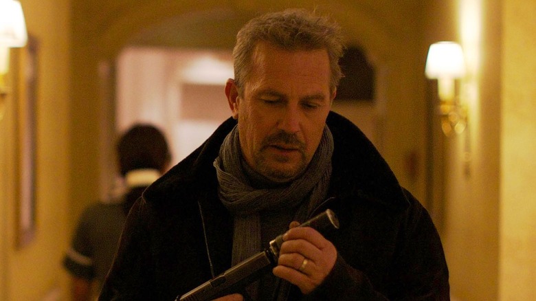 Kevin Costner puts silencer on gun