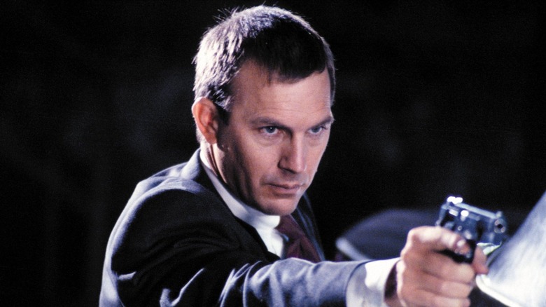 Kevin Costner aims gun