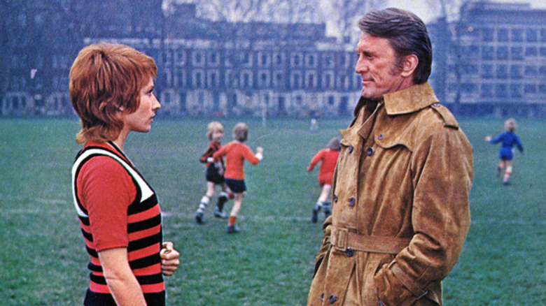 kirk douglas talks to a woman in a park