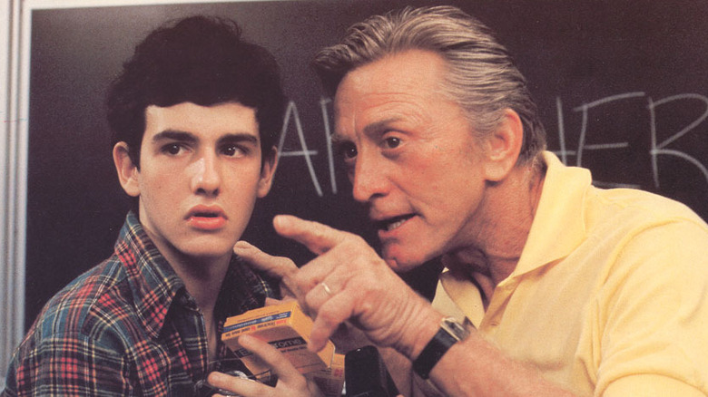 kirk douglas shows a student something
