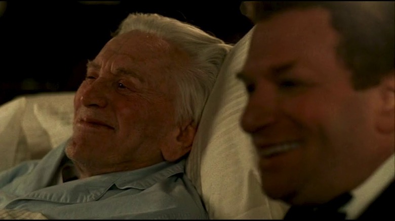 kirk douglas lays in bed