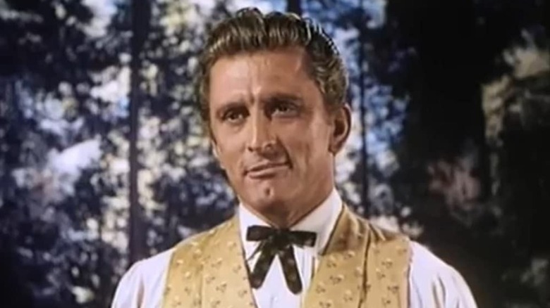 kirk douglas smirks in the forest