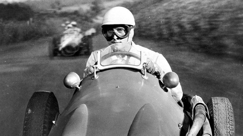 kirk douglas behind the wheel of a racecar