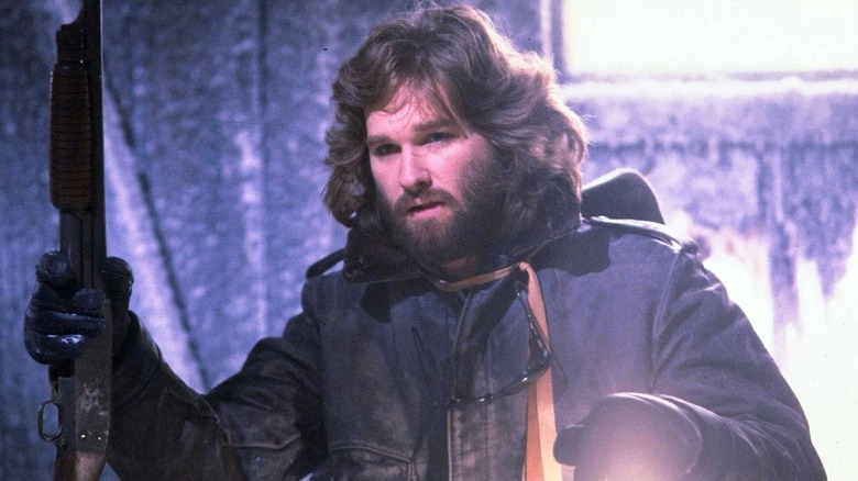 Kurt Russell holds a shotgun