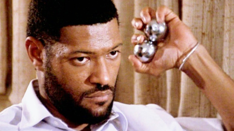 Laurence Fishburne as Jason 'Furious' Styles Jr. holding stress balls