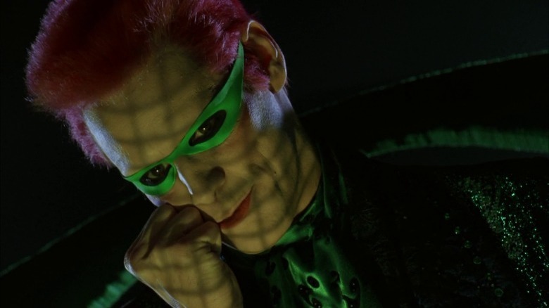The Riddler resting his head against his fist