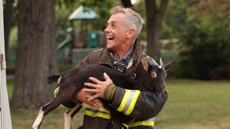 Christopher Herrmann holding baby goat