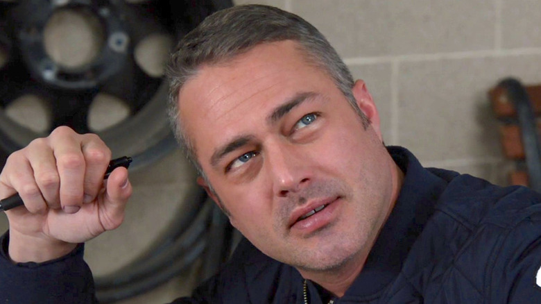 Kelly Severide grips pen