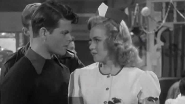 Monroe talking to man in waitress outfit 