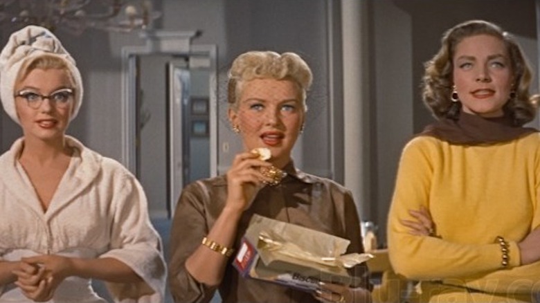 Monroe, Grable, and Bacall standing in hotel 