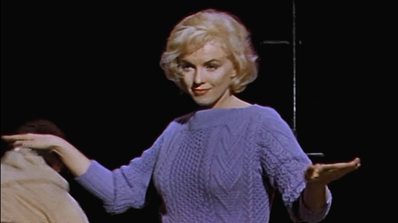 Monroe performing in purple sweater