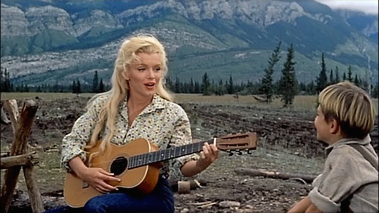 Monroe playing guitar and singing for boy in the wilderness 