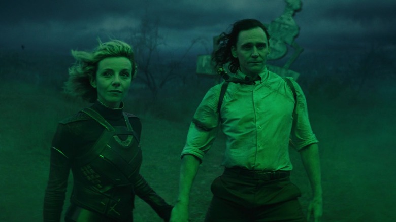 Loki and Lady Loki immersed in green light