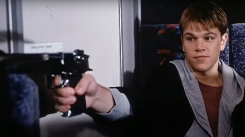 Matt Damon holds gun