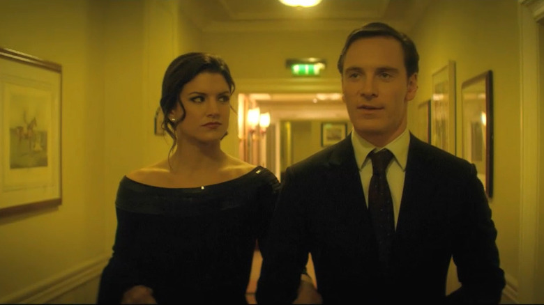 Gina Carano and Michael Fassbender walking down hallway