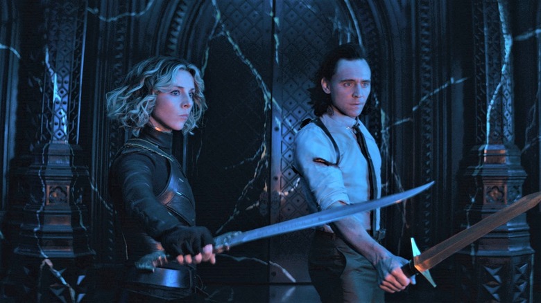 Loki and Sylvie hold swords