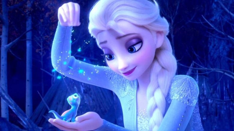 Elsa sprinkles a spell on a lizard