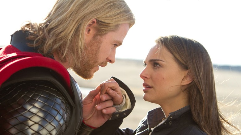 Thor holding Portman's hand 