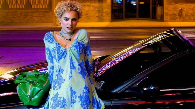 Blonde Portman standing in front of car