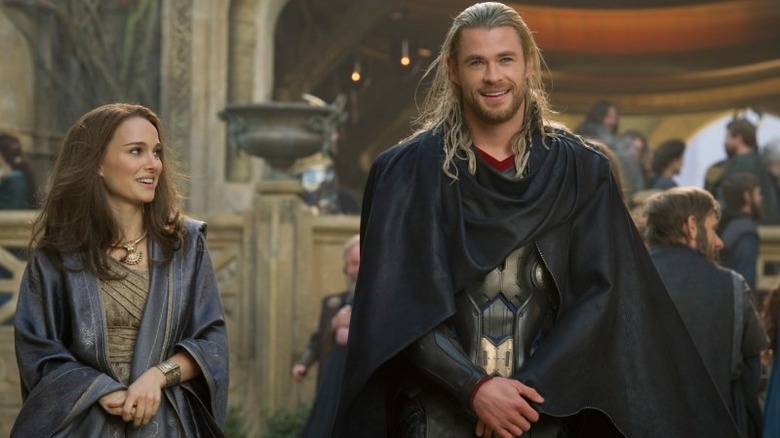 Jane and Thor standing in cloaks on Asgard