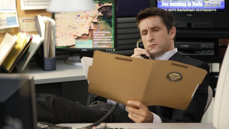 Agent Bret Langer reading a file