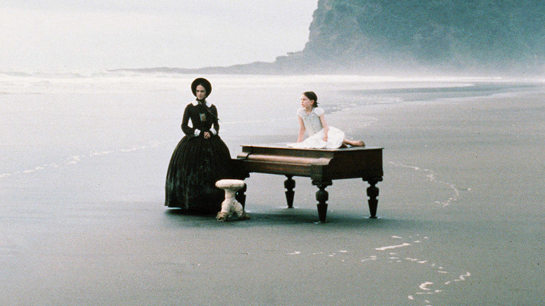 Ada and Flora McGath with a piano on a beach