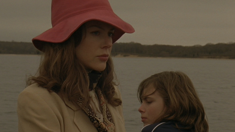 Kidman and kid stand by water