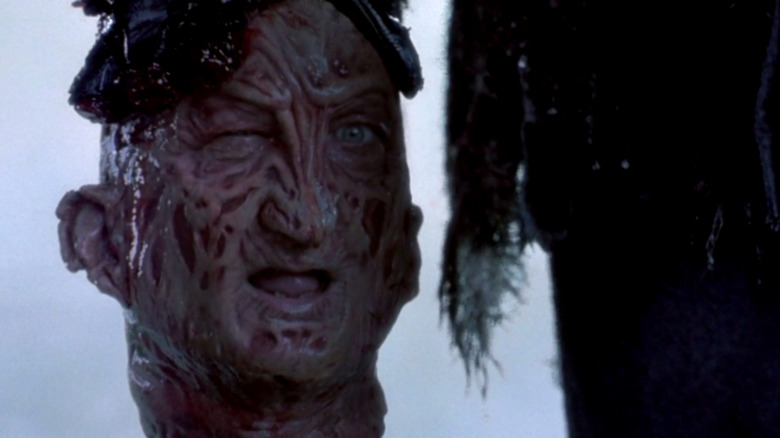 Freddy winks as Jason carries him out of the water.