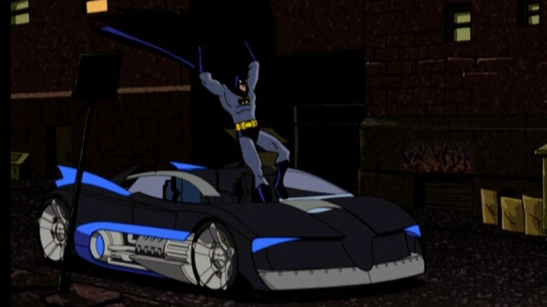 Batman jumping into Batmobile